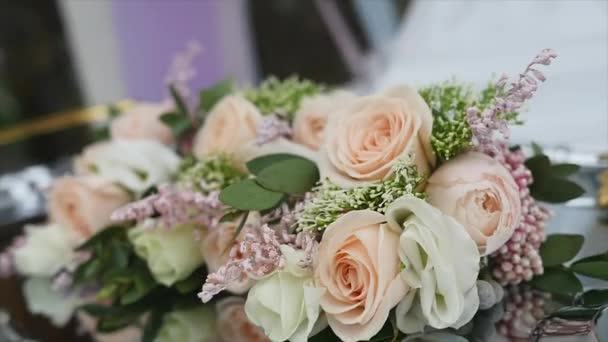 Bride bouquet of flowers, Beautiful bridal bouquet on the table, groom boutonniere, Wedding day, Brides bouquet. wedding preparations — Stock Video