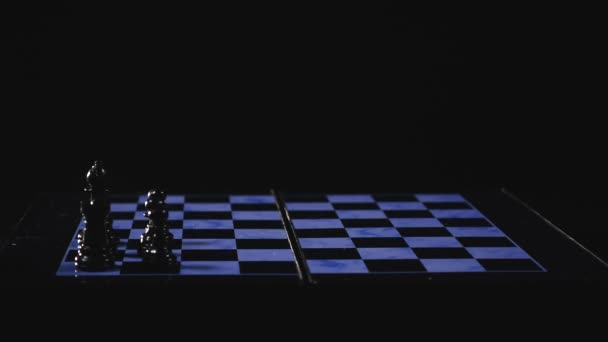 Chess boards and chess pieces game on black background. time lipse — Stock Video