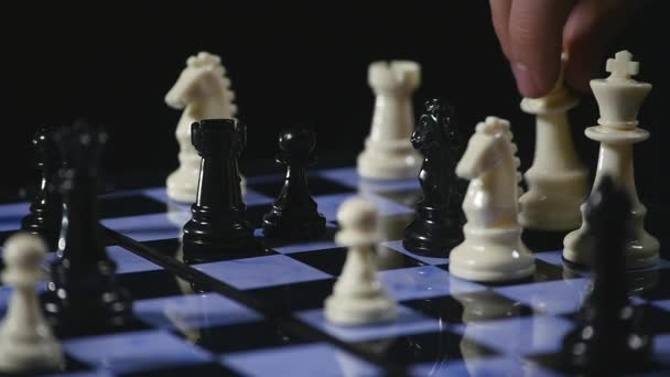 Chess boards and chess pieces game on black background — Stock Video