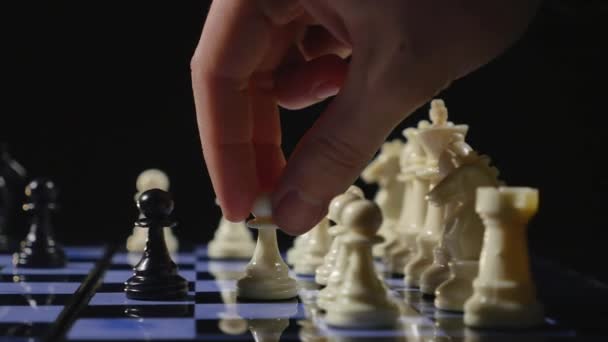 Chess boards and chess pieces game on black background — Stock Video