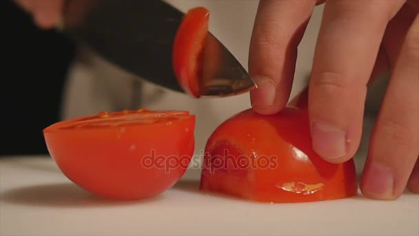 Chef cutting up a tomato with a knife. close up — Stock Video