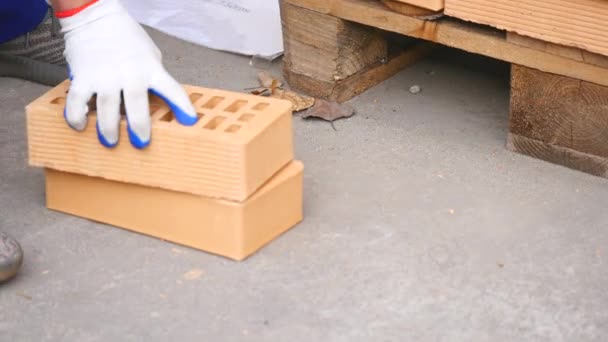 Close-up: worker sets the brick at warehouse — Stock Video