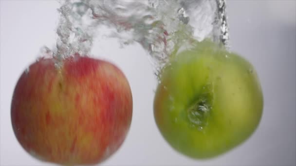 Apples falling in water in aquarium — Stock Video