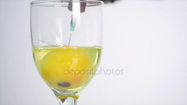 Yemas de huevo en vidrio sobre fondo blanco — Vídeos de Stock