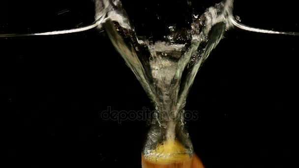 Potato slices falling in water on black background — Stock Video