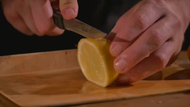 Кто-то режет лимон на доске — стоковое видео