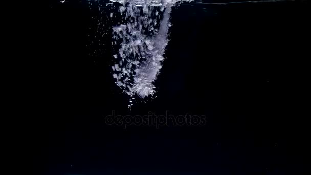 Pouring water and making splashes on black background — Stock Video