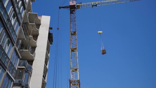 Site de construction avec grues sur fond de ciel — Video