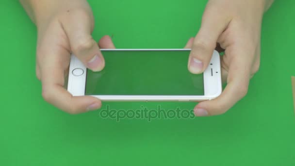 Using smart phone on green screen with various hand gestures, horizontally , close up - green screen — Stock Video