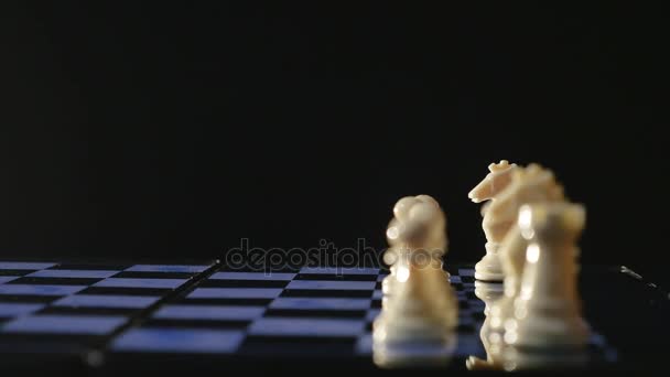 Chess boards and chess pieces game on black background — Stock Video