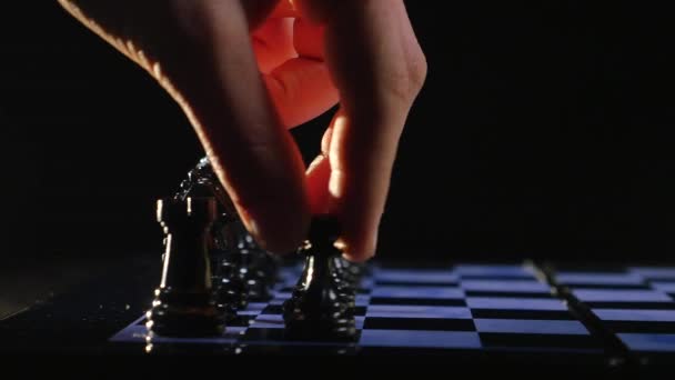 Chess boards and chess pieces game on black background — Stock Video