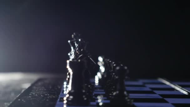 Chess boards and chess pieces game on black background — Stock Video