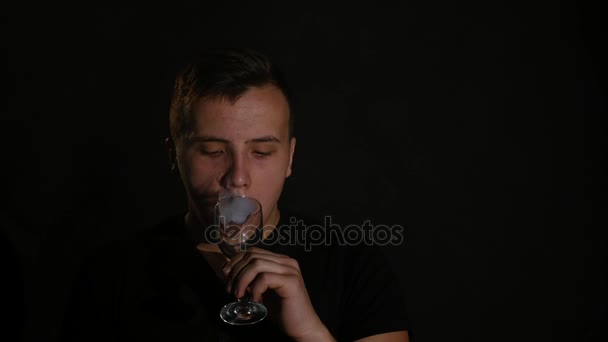 Man smoking electronic cigarette vapor on black background — Stock Video