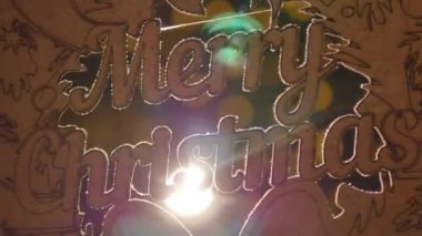 metinle Merry christmas Noel ışıkları arka plan üzerinde ahşap işareti