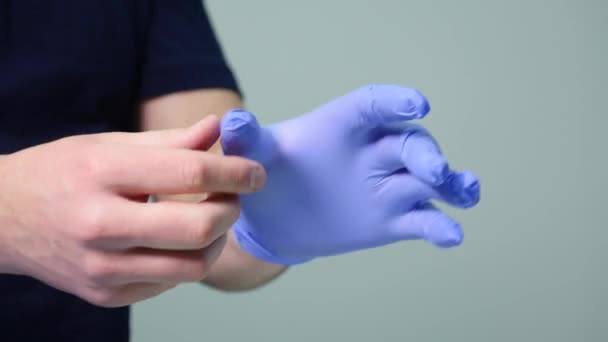 The doctor wears sterile latex gloves — Stock Video