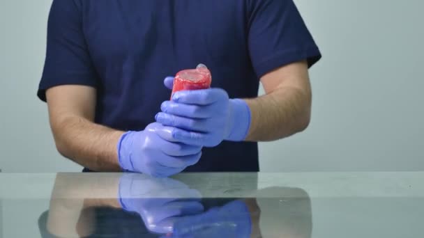 Bir prezervatif bir mum üzerinde giyen bir adam elinde — Stok video