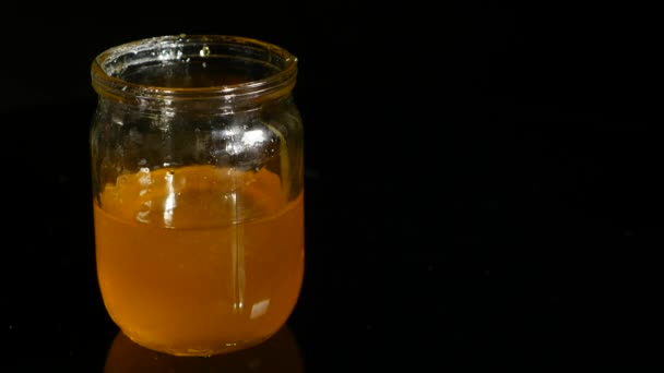 Honey jar on a black background — Stock Video