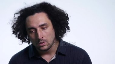 Beyaz arka planda siyah gömlekli karizmatik sakallı genç adam farklı duygular gösterir