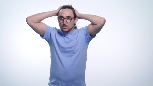 Young handsome man correcting hair, smiling over white background — Stock Video