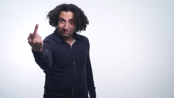 Portrait of a young man showing middle finger gesturing fuck on white background — Stock Video