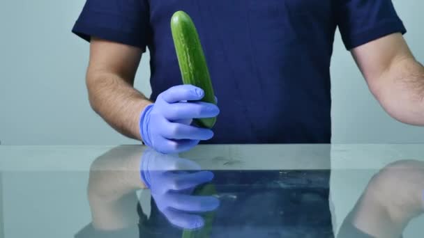 Male hands holding cucumber and condom. Safe sex concept