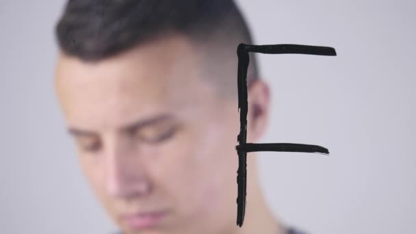 Close-up of a Man writes on a Glass Whiteboard — Stock Video