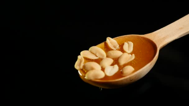 Honey and nuts on wooden spoon close up — Stock Video