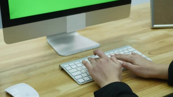 Primer plano de la mano de la mujer escribiendo en el teclado de la computadora en la oficina moderna en la mesa — Vídeos de Stock