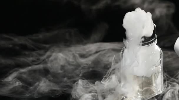 Abstract white smoke in glass the effect from dry ice on dark background — Stock Video