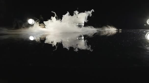 Close-up of ice smoke in bowl against black background — Stock Video