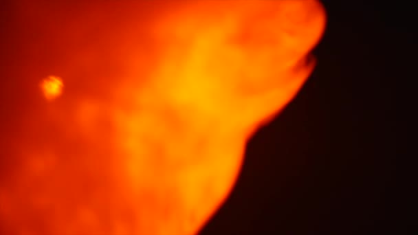 Red smoke flame on isolated black background — Stock Video