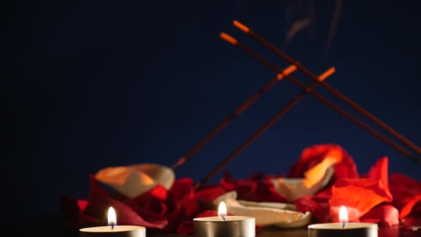 Incense sticks and candles are burning and smoke on dark background,Smoke from incense and candle light — Stock Video