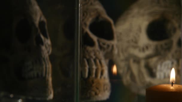 Candle on Skull in an aquarium background — Stock Video