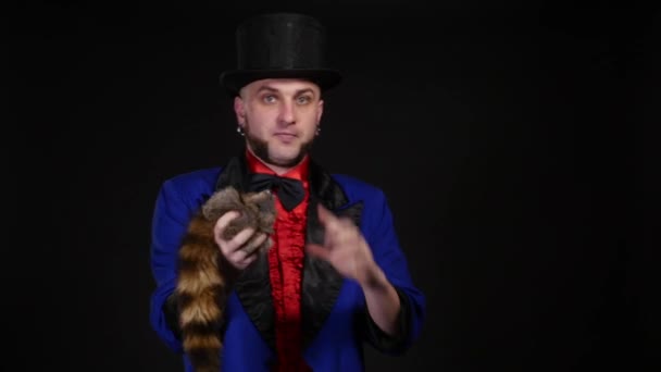 The magician shows tricks on black background — Stock Video