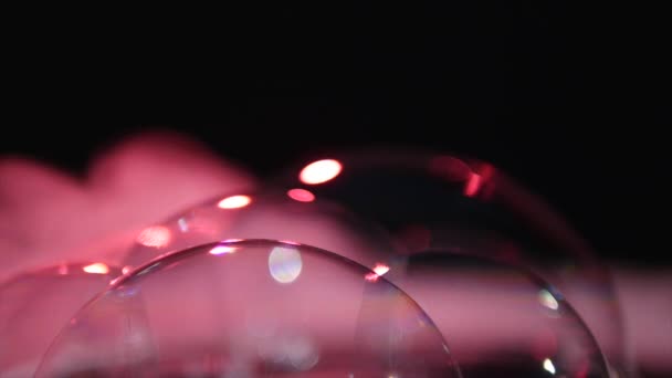 Pink soap bubbles with smoke on black background — Stock Video