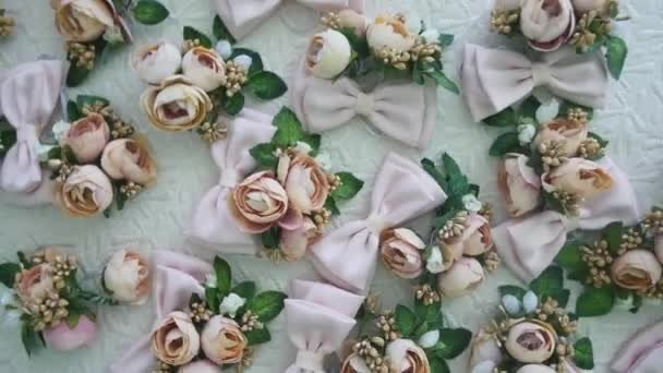 Beautiful wedding boutonnieres on the bed — Stock Video