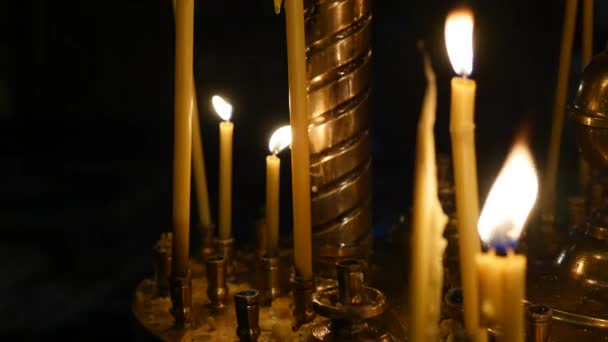 Velas encendidas en el candelero en la iglesia — Vídeos de Stock