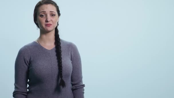 Young sad woman cry over white background — Stock Video