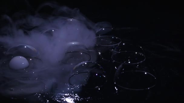 Soap bubbles with smoke on black background — Stock Video