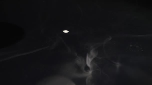 Smoke billowing over a black background — Stock Video