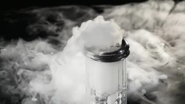 Abstract white smoke in glass the effect from dry ice on dark background — Stock Video