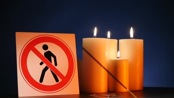 Many burning light wax candles with waving yellow flame with the sign for people entrance is forbidden on black background. Round thick blazing sticks for celebrating events and lightening — Stock Video