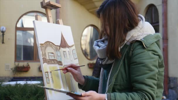 De jeunes artistes dessinent dans la ville. Artistes peinture tableau dans la rue. Les étudiants peignent la construction de la vieille ville européenne — Video