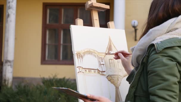 Jovens artistas atraem a cidade. Artistas a pintar quadros na rua. Estudantes pintam a construção da velha cidade europeia — Vídeo de Stock
