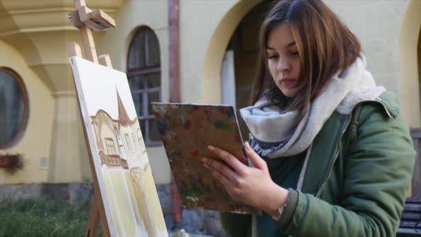 Νέοι καλλιτέχνες ισοπαλία στην πόλη. Καλλιτέχνες, ζωγραφική εικόνα στο δρόμο. Φοιτητές χρώμα κτηρίου της παλιάς ευρωπαϊκής πόλης — Αρχείο Βίντεο