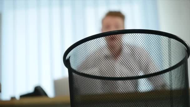 Man throws away paper documents and rejoices that he has fallen into the basket. slow motion — Stock Video