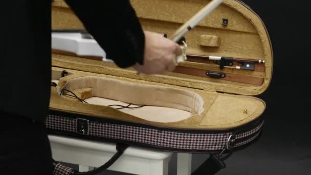 Violín blanco sobre una silla blanca sobre fondo negro — Vídeo de stock