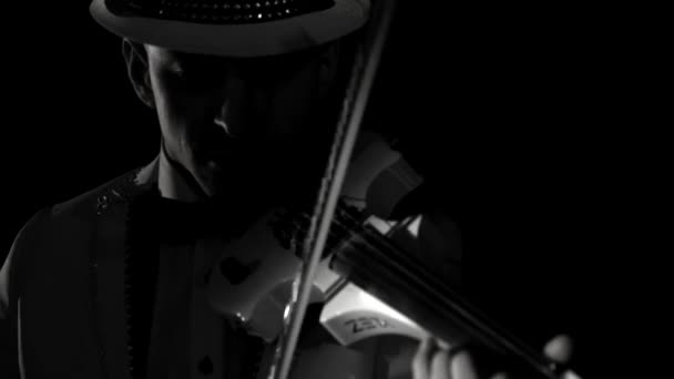 Violinist man playing the violin on a black background. Close up — Stock Video