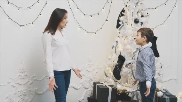 Mother asking her little son if he was good boy during the year, the other way she will not get a present. Kid becomes upset but mother becalms him. — Stock Video