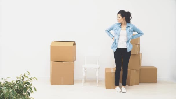 Silná žena nese velkou pohyblivou krabici plnou věcí, izolovaných na bílém pozadí. 4k. — Stock video